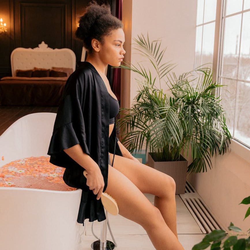 woman dry brushing her leg