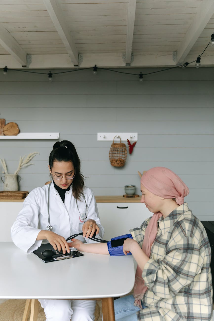 a doctor checking a woman s blood pressure